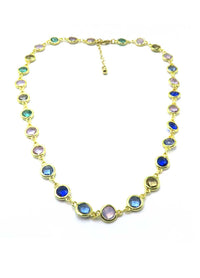 A gold-plated link necklace featuring oval and round bezel-set multicolor gemstones, displayed on a clean white background.