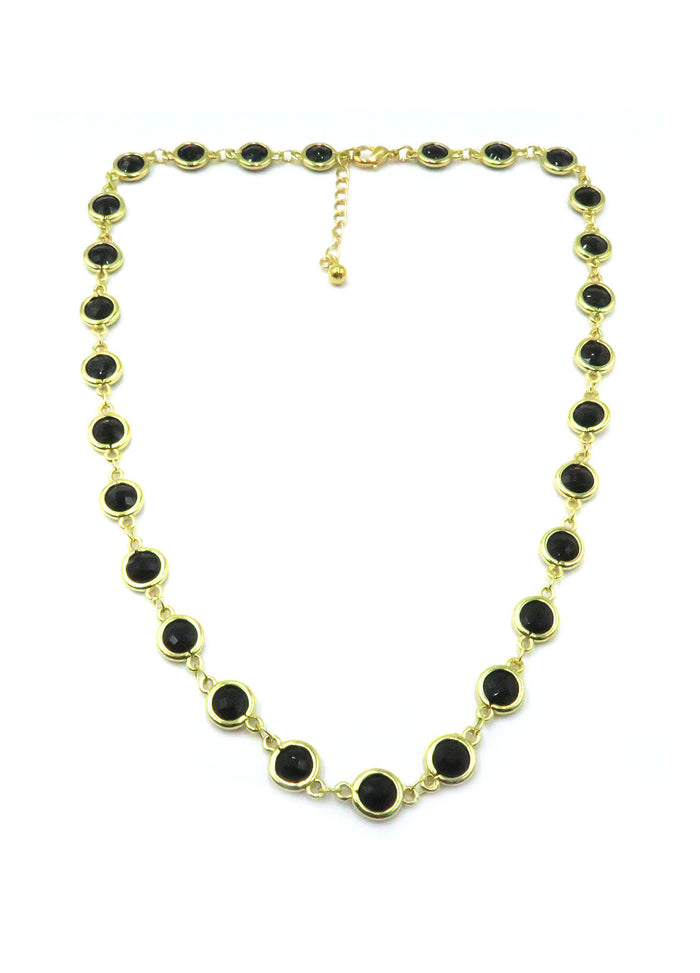 A gold-tone chain necklace featuring multiple oval black stones set in gold bezels, displayed on a clean white background with a small clasp extension.