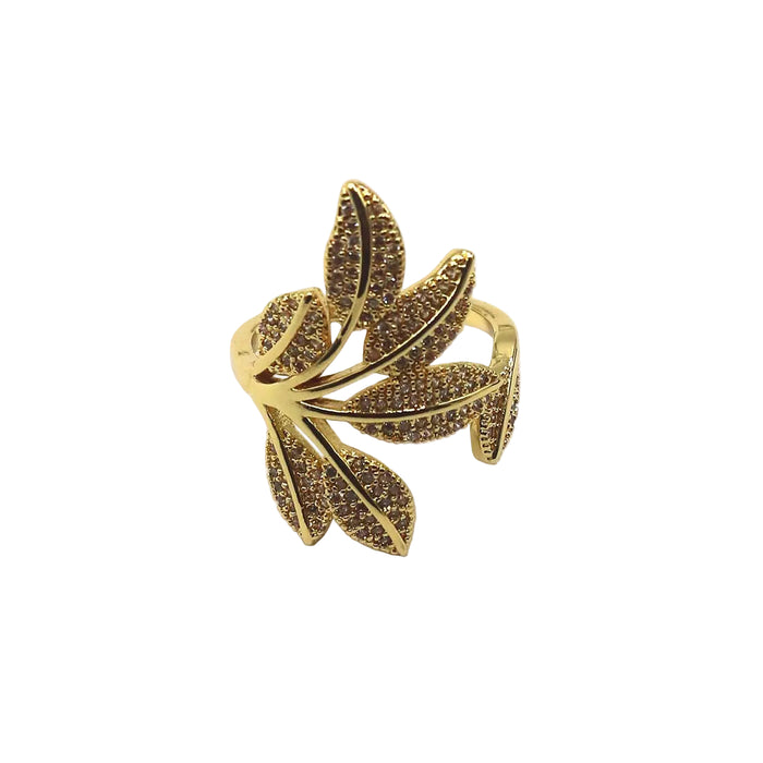 A gold leaf-shaped ring embellished with small brown stones, shown on a plain white background with text labels in the corners.