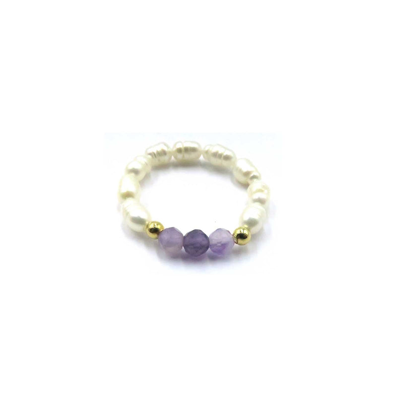 A beaded stretch bracelet featuring cream-colored baroque pearls, three faceted purple amethyst beads, and two small gold spacer beads, displayed on a clean white background with product codes.